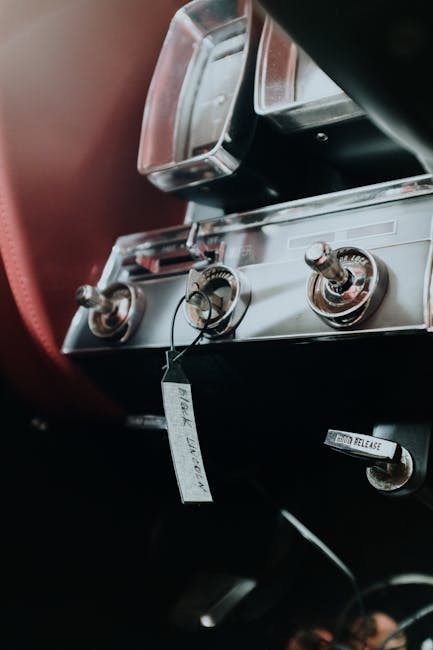 Close-up of a classic car dashboard with vintage controls and chrome accents.